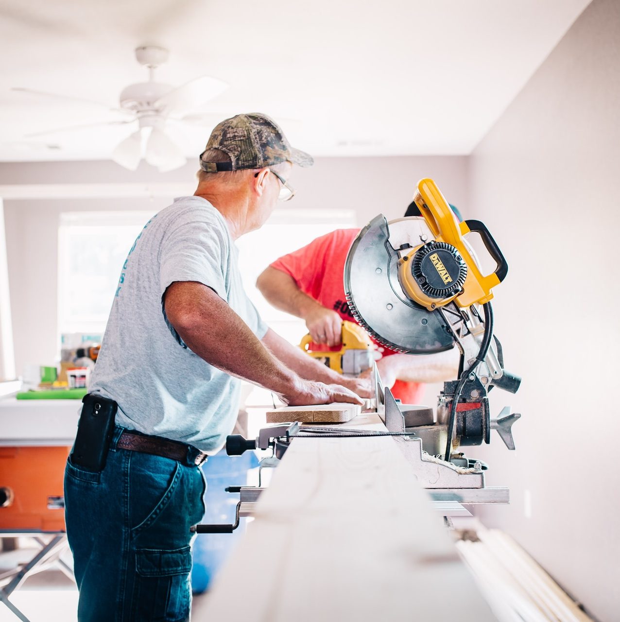 man standing infront of miter saw